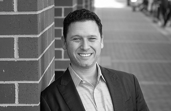 Man leaning against wall and smiling