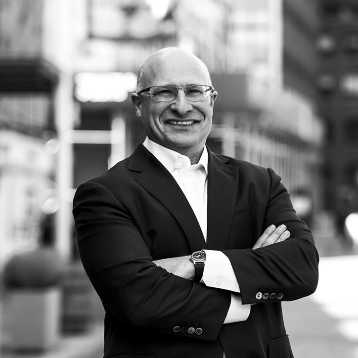 Man smiling with his arms crossed