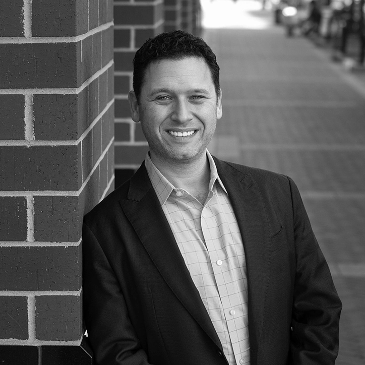 Man leaning against wall and smiling