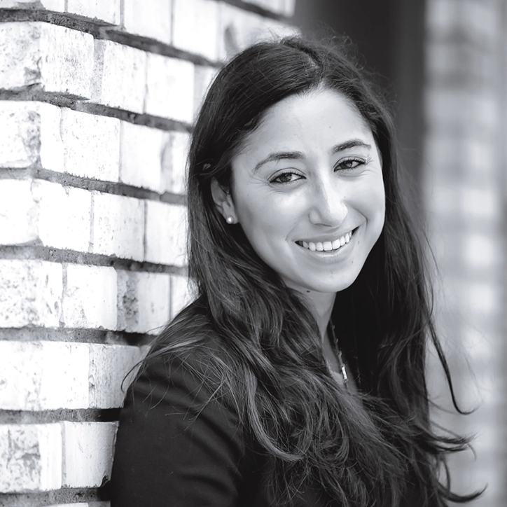 Woman leaning against wall and smiling