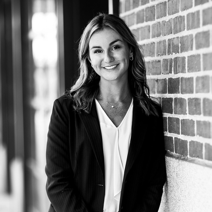 Woman leaning against wall and smiling