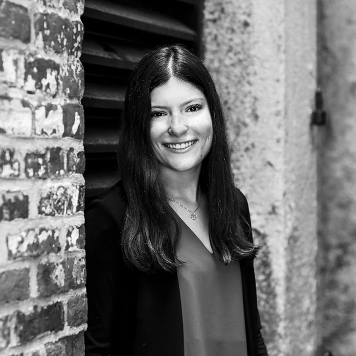 Woman leaning against wall and smiling