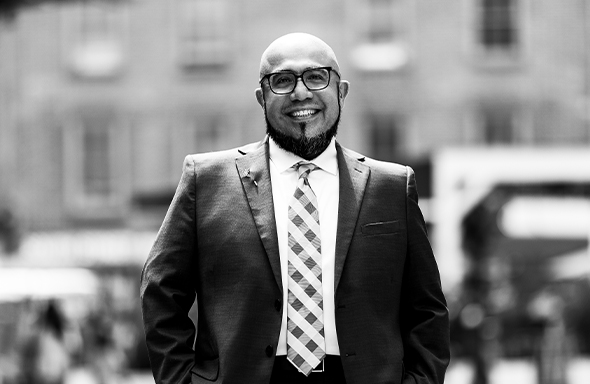 Man smiling with his hands in his pockets