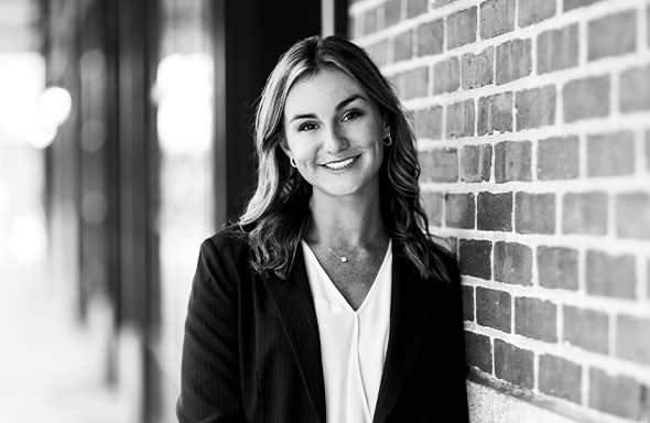 Woman leaning against wall and smiling